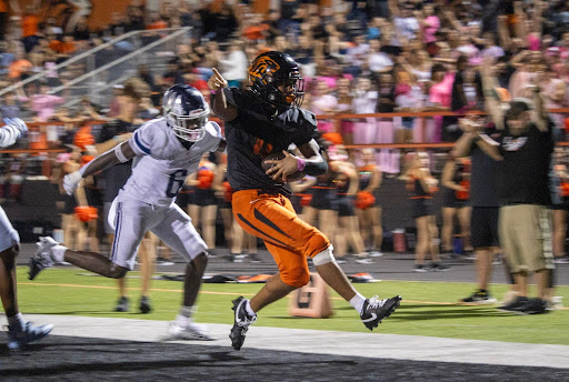 No. 4 running back Johnnie Cobbs celebrates amidst another touchdown. A junior this year, Cobbs is an essential part of the team.