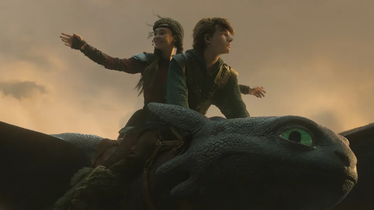 Hiccup (Mason Thames) and Astrid (Nico Parker) ride Toothless the Night Fury dragon in "How to Train Your Dragon" (2025). Image courtesy of Universal Pictures.