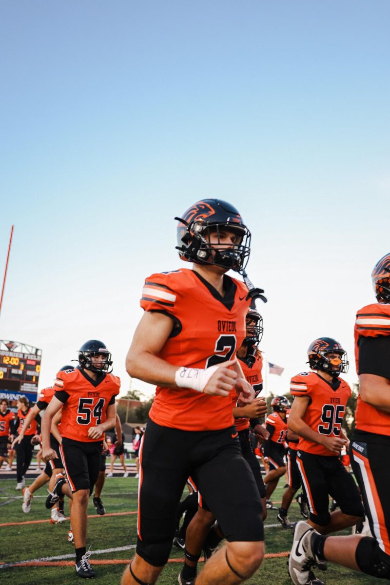 Senior wide receiver Brock Joyce (2) runs onto the field, hungry for victory against Eustis High School on Oct. 30.