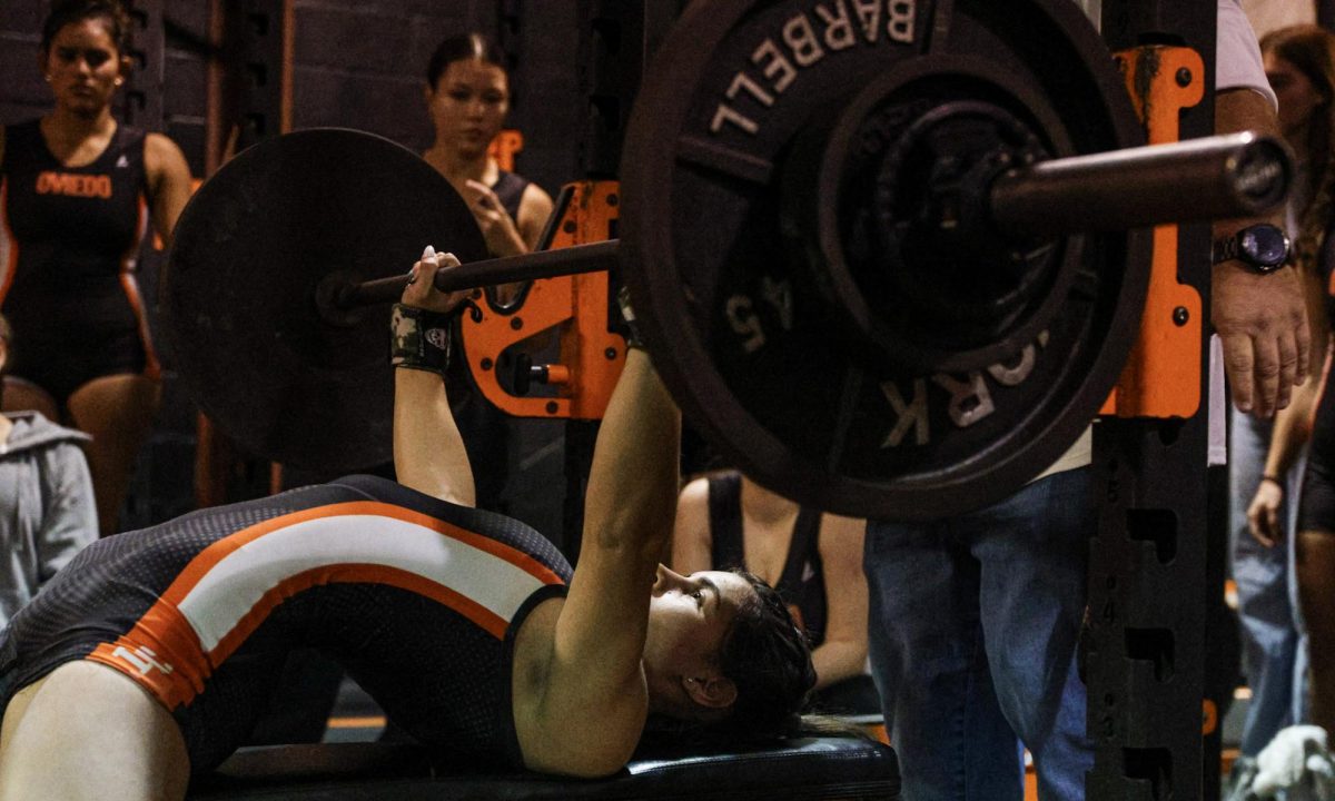 On Wednesday, Dec. 3 Senior Marnee McCue powers through a bench press at the meet against Seminole.