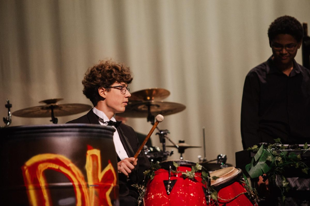 Sophomore Liam O'Neal plays a pair of red conga drums during the song "Donkey Kong Country" from the "Donkey Kong Country" video games.