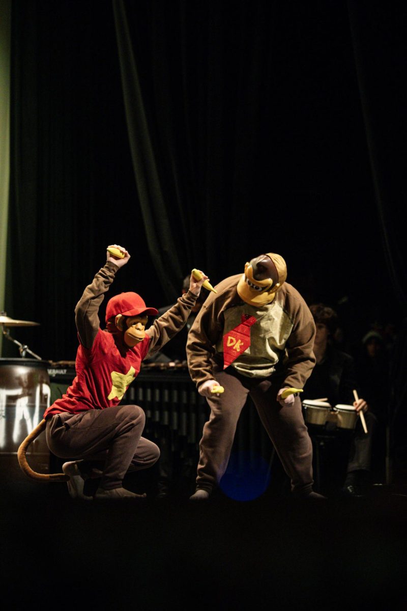 Percussion students dressed as Diddy Kong and Donkey Kong from the "Donkey Kong" video games perform as the famous pair of primates, triumphantly holding bananas.