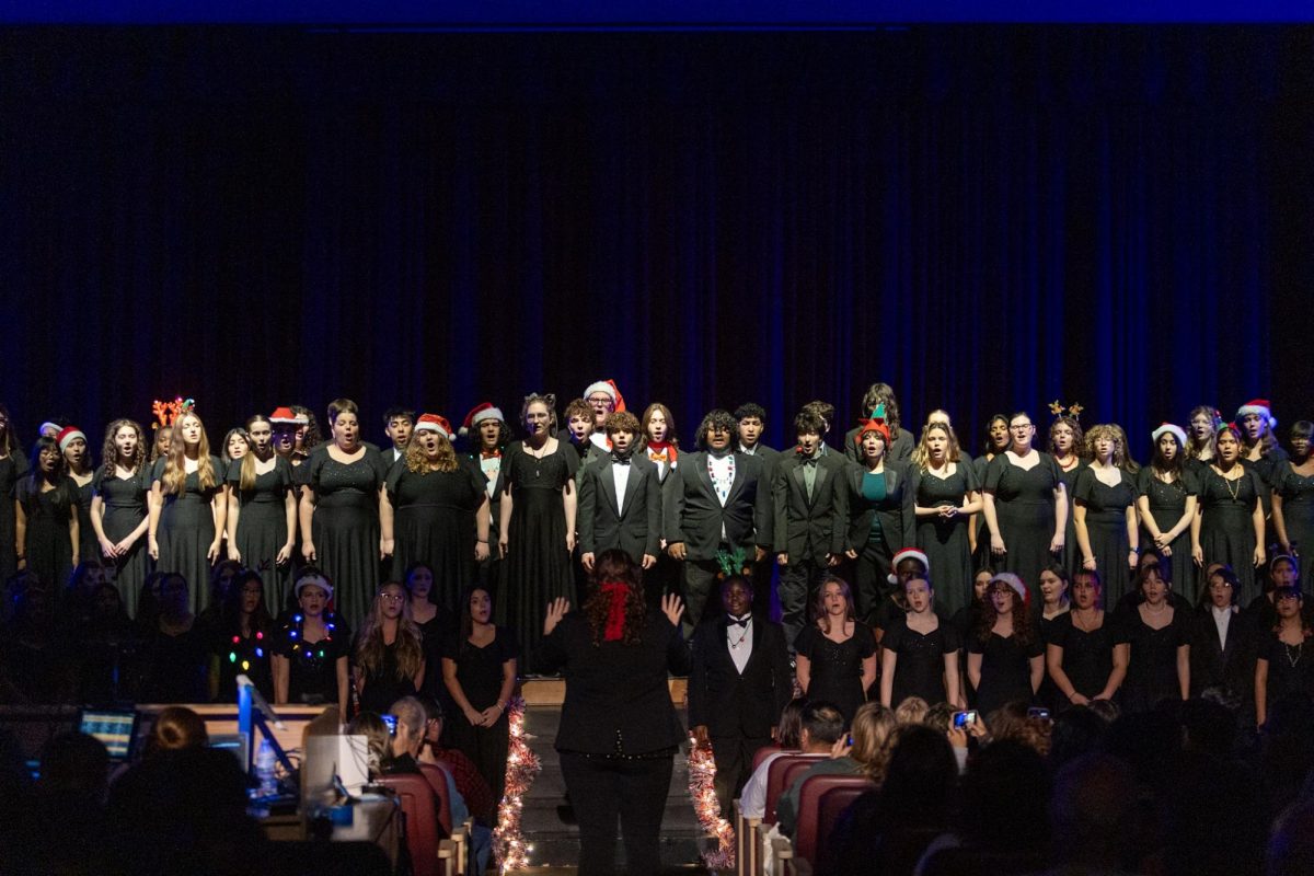 Choir director Morgan Watts (bottom center) conducts the unified choir, composed of each choir group combined, in a performance of "O Holy Night."