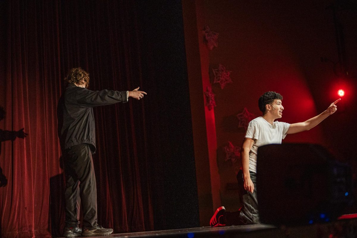 Junior Ryan Davis and sophomore Noah Galindez perform a scene from "Of Mice and Men," with Davis playing George and Galindez playing Lennie.
