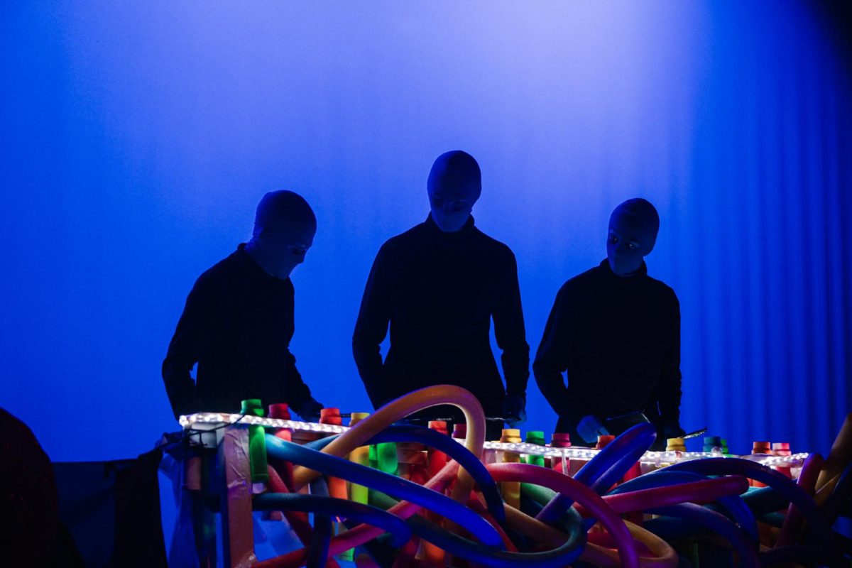 Three percussion students perform a holiday mash-up as the Blue Men from the Blue Man Group.