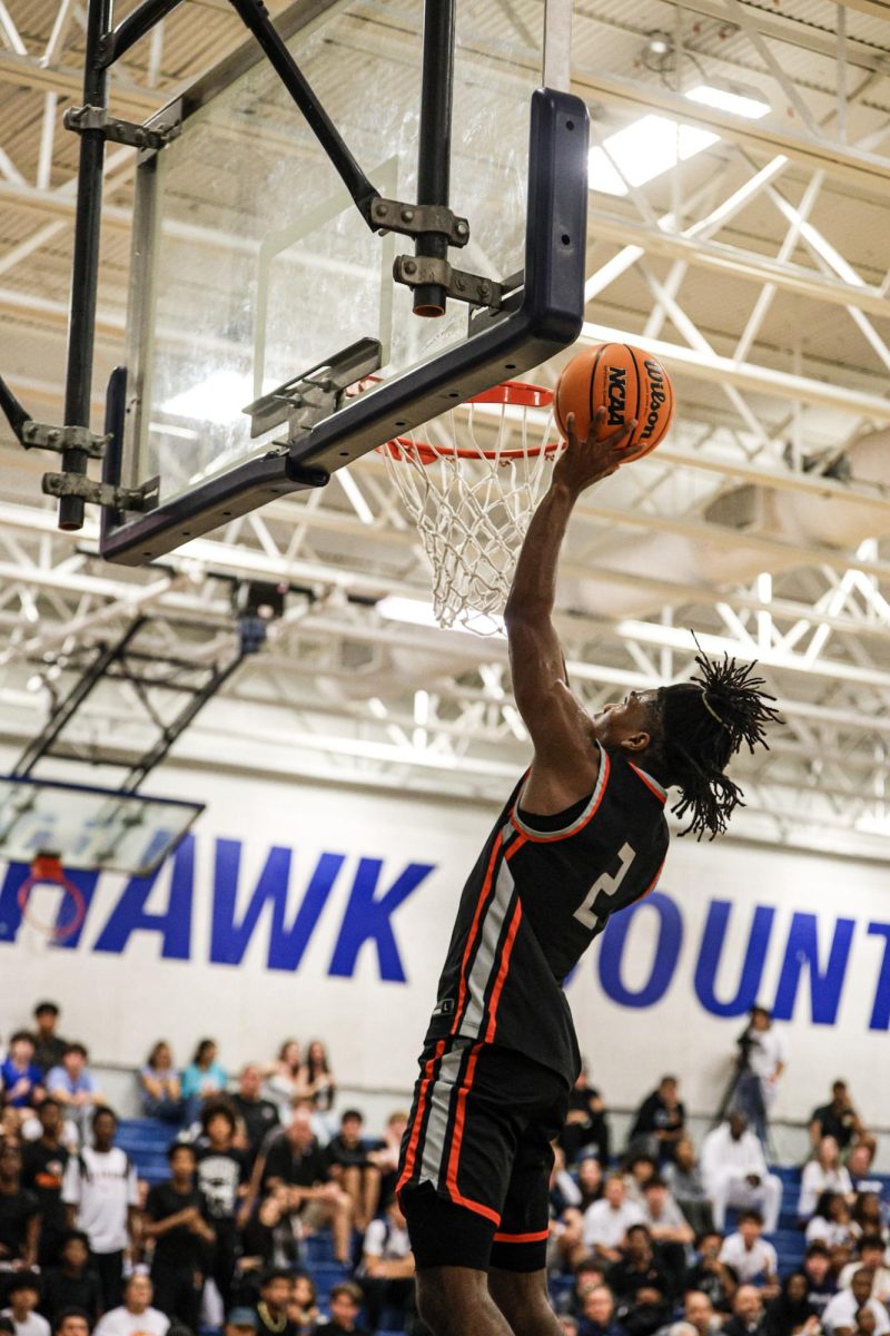 Carter Oden (2), junior, dunking at the Dec. 4 game against Lake Howell High School.