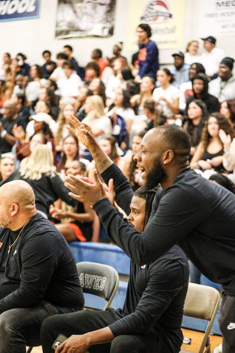 Head coach Ian Young cheering on the team from the sidelines. 