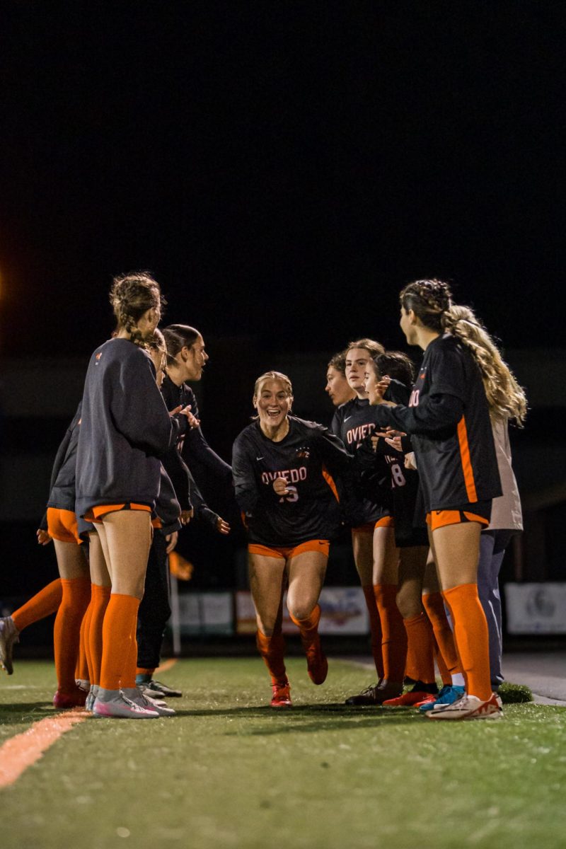 Payton Pitman runs through a tunnel of her teammates as they congratulate her.