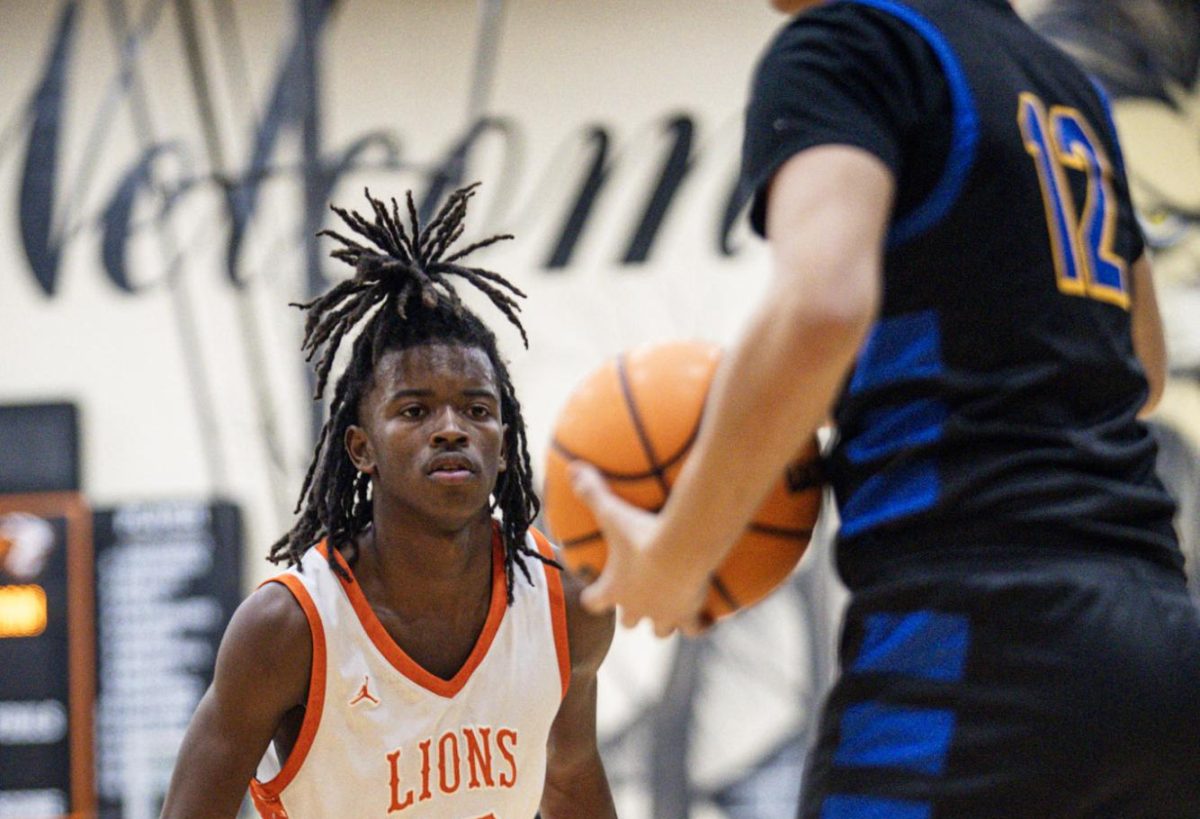 Junior shooting guard Azariah Critton keeps his eyes on the ball during the game.