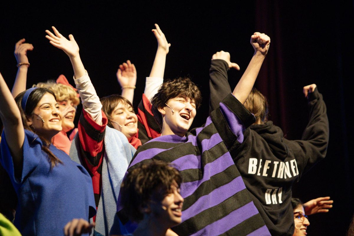 Schroeder (center; Evan Colmenero, 12) celebrates his idea for a "Beethoven Day" holiday as the ensemble cheers for him.