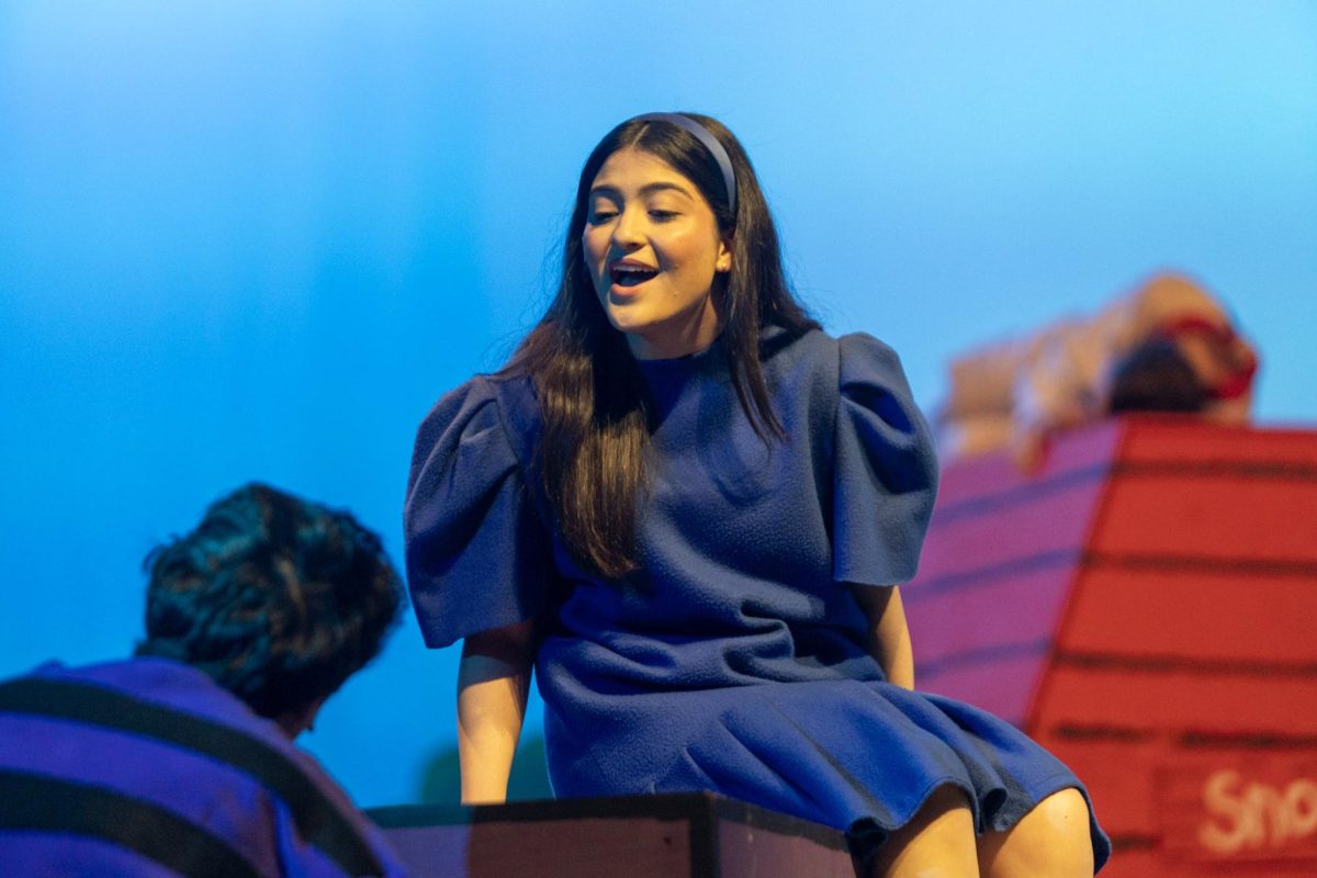 As Schroeder (Evan Colmenero, 12) plays the piano, Lucy van Pelt (Emma Bremer, 12), who has a crush on him, sings about how she would like to marry a musician.