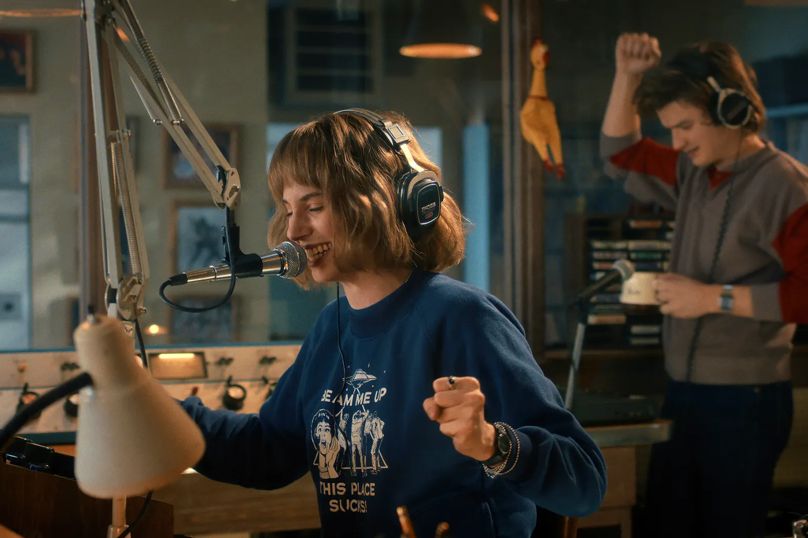 Robin Buckley (Maya Hawke) and Steve Harrington (Joe Keery) dance during a radio broadcast of the WSQK The Squawk. Image courtesy of Netflix.