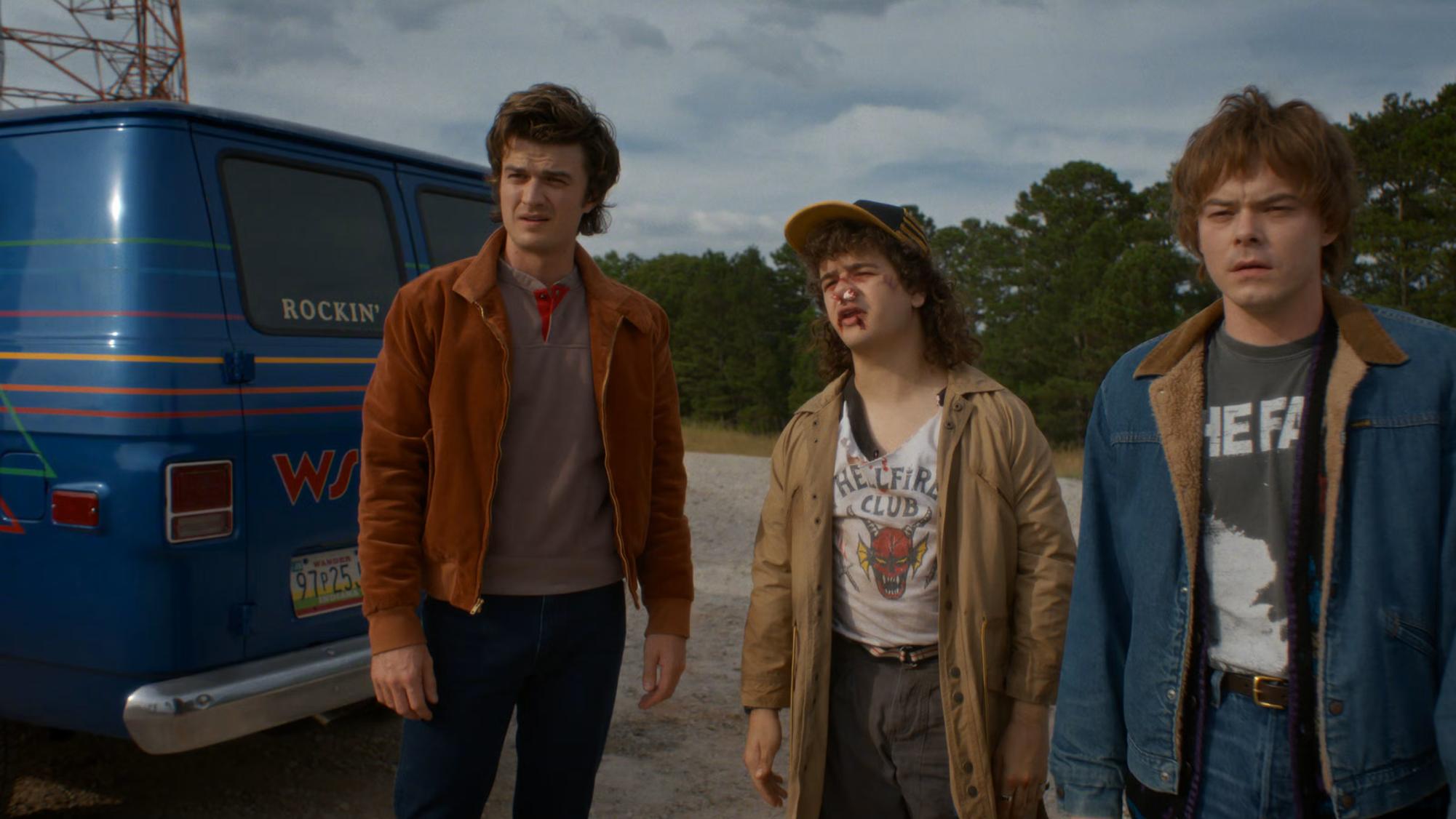 Steve Harrington (Joe Keery) arrives at the WSQK radio station with Dustin Henderson (Gaten Matarazzo) and Jonathan Byers (Charlie Heaton) moments before another car with the rest of the crew. Image courtesy of Netflix.