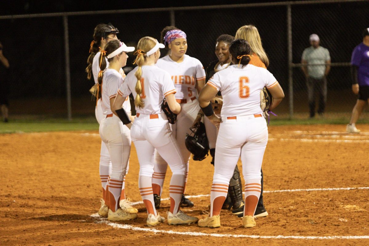 Coach Morley hypes up the varsity softball team in their game against Winter Springs on March 3. 