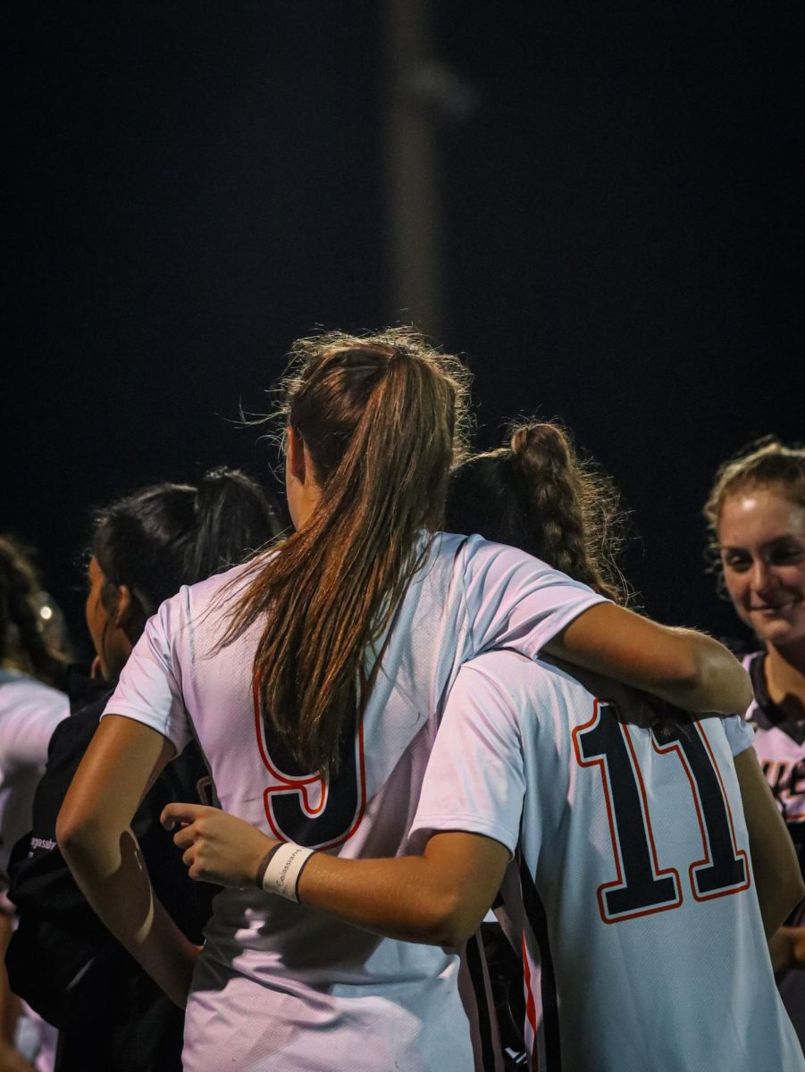 Freshman Presley Krantz and sophomore Gianna Lunardi hugging after their match against Vero Beach.