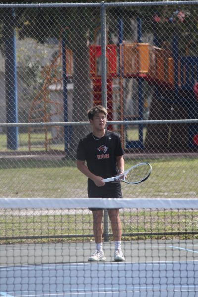 Junior Caden Park holds his racket in between matches in the game against Oviedo's rival, Hagerty.