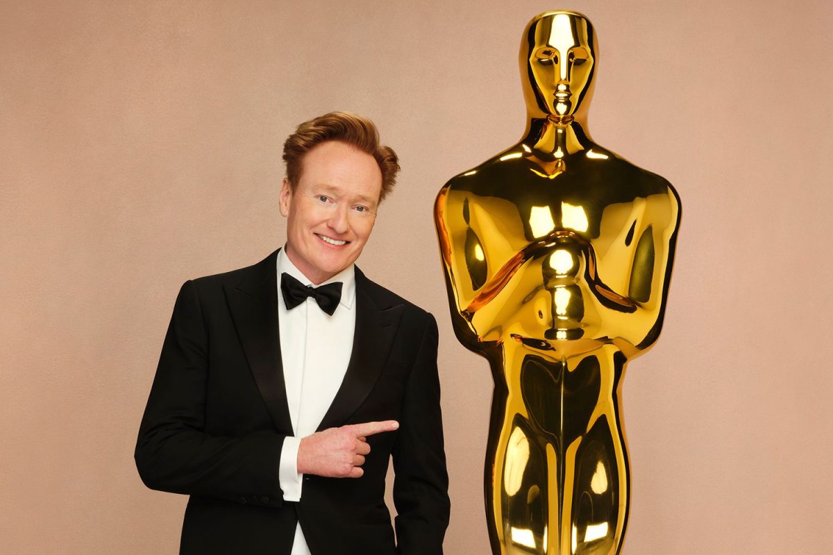 Conan O'Brien, the host of the 97th and 98th Academy Awards, poses next to the Oscar statuette. Image courtesy of Disney/Andrew Eccles.